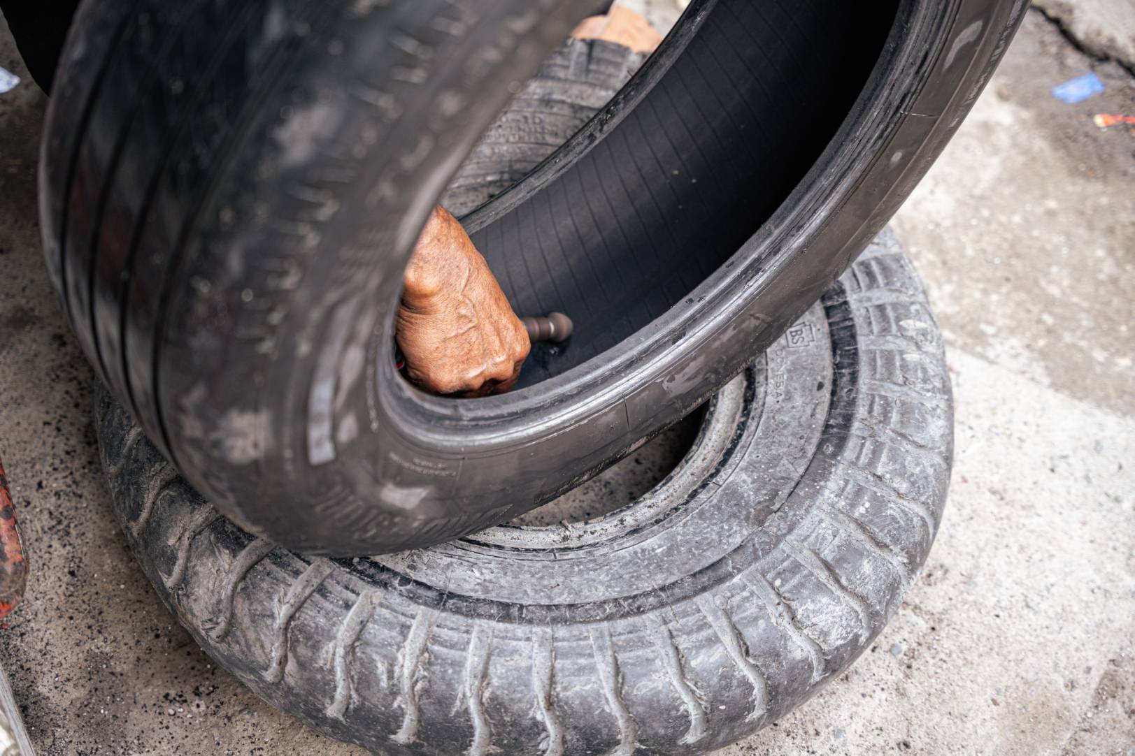 man fixing a car tire puncture