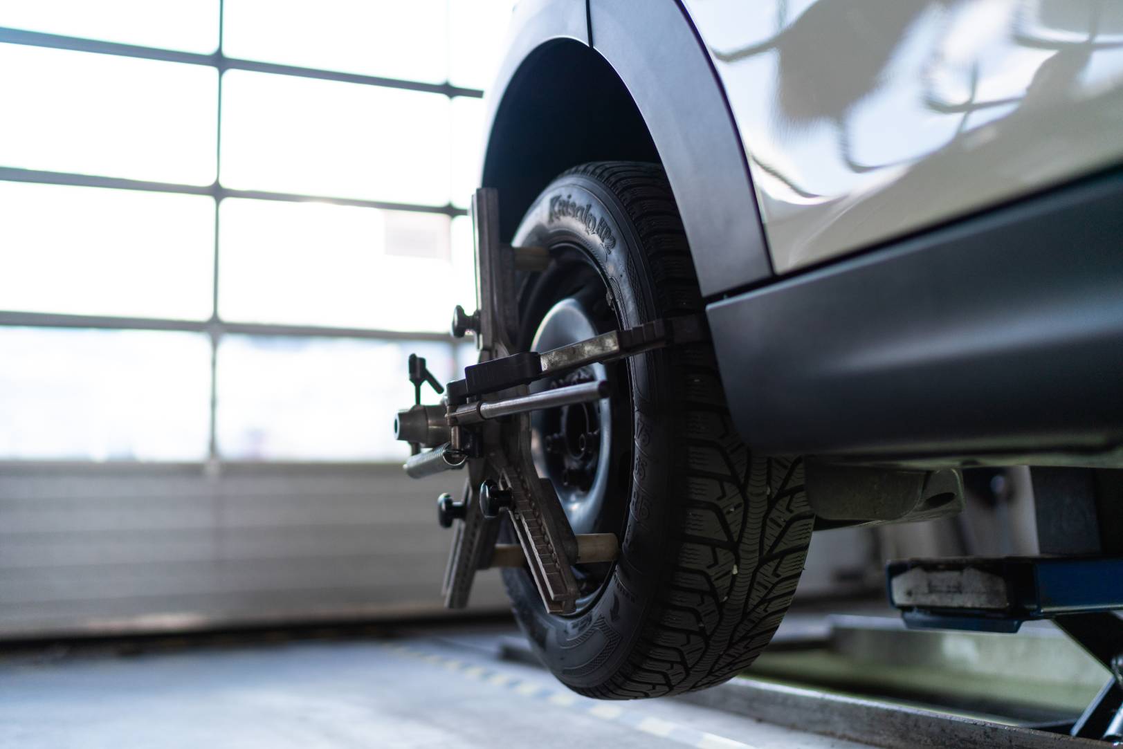 Car in an auto shop getting a wheel alignment